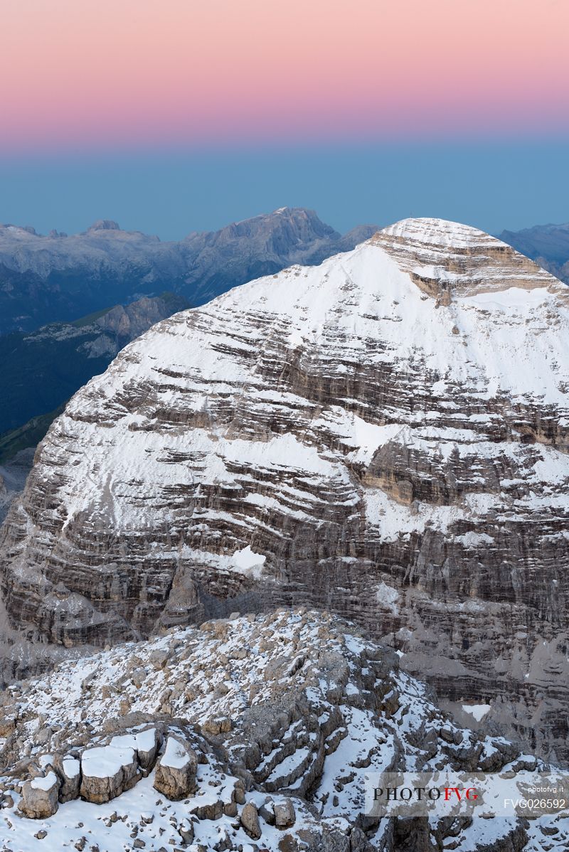 Dawn from the top of Tofana di Mezzo (3244 m) towards Tofana di Rozes after a slight summer snowfall, Cortina d'Ampezzo, dolomites, Italy