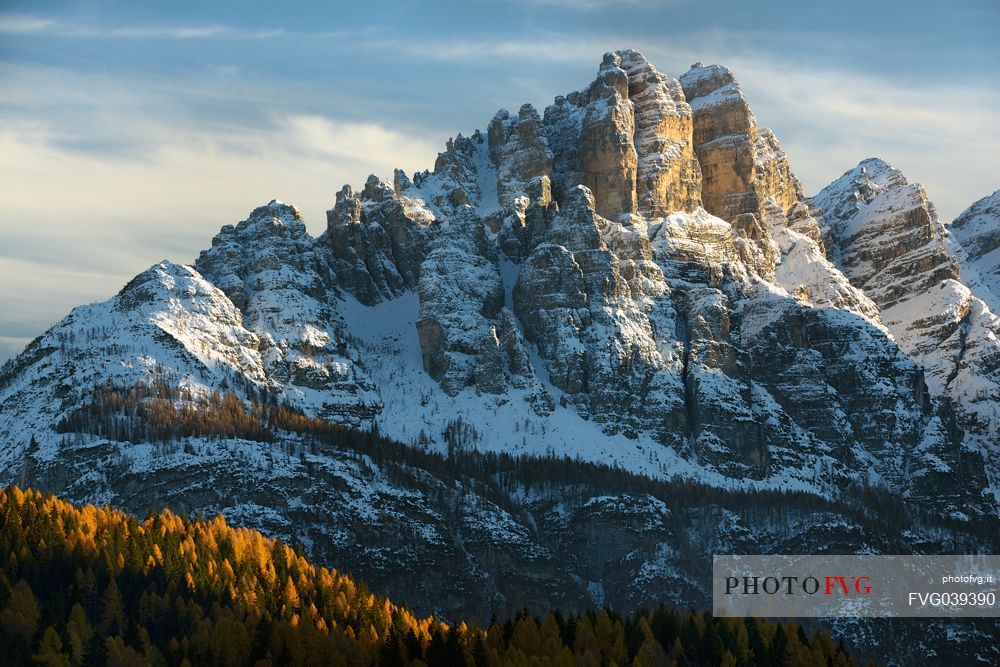 Autumn sunset on the Spiz di Mezzod Group in Val Zoldana. Characterized by the colorful larch forest, dolomites, Veneto, Italy, Europe