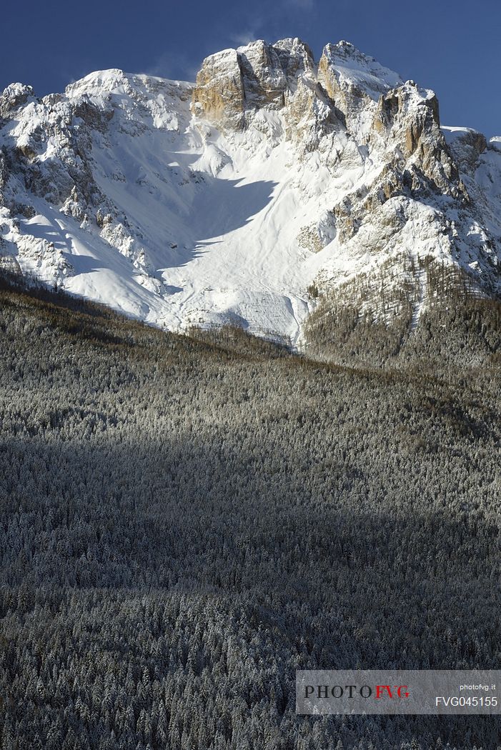 Comelico valley in a winter day, in the background the Croda da Campo peak in the Sesto dolomites, Veneto, Italy, Europe