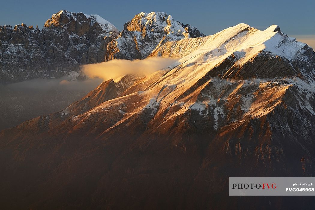 Winter panorama towards Gusela del Vescov, Mount Schiara, Mount Pelf and Mount Serva at sunset, dolomites, Belluno, Veneto, Italy, Europe.