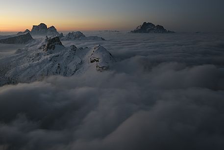 Sunrise from the top of the mountain Lagazuoi towards the Dolomites of Cortina and Zoldana valley.
Cold and windy winter morning with the phenomenon of thermal inversion, dolomites, Italy