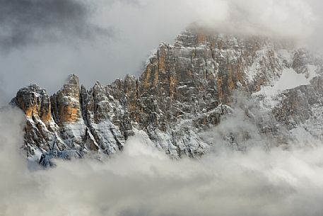 The north-west wall of the Civetta mount wrapped in stormy cloud, dolomites, Italy