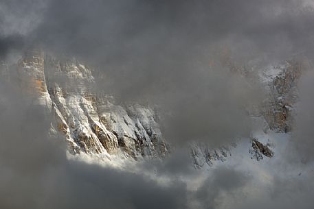 The north-west wall of the Civetta mount wrapped in stormy cloud, dolomites, Italy