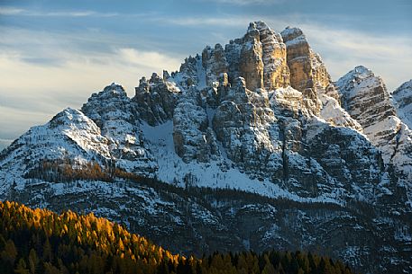 Autumn sunset on the Spiz di Mezzod Group in Val Zoldana. Characterized by the colorful larch forest, dolomites, Veneto, Italy, Europe