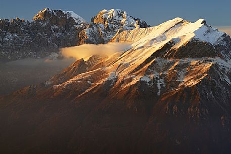 Winter panorama towards Gusela del Vescov, Mount Schiara, Mount Pelf and Mount Serva at sunset, dolomites, Belluno, Veneto, Italy, Europe.