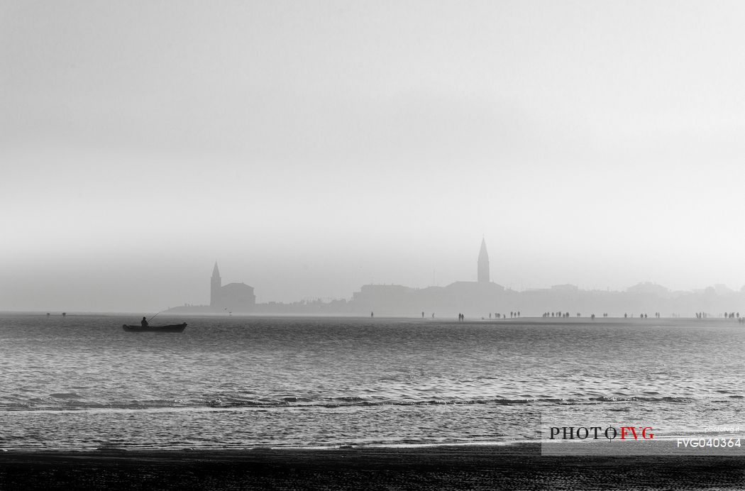 The promenade of Caorle on a evening of autumn, Santuario della Madonna dell'Angelo in background, Adriatic coast,  Veneto, Italy, Europe