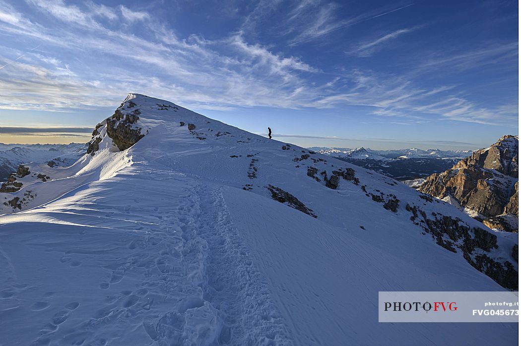 Hiker near the summit of Piccolo Lagazuoi just before sunset, Falzarego, Cortina d'Ampezzo, dolomites, Veneto, Italy, Europe