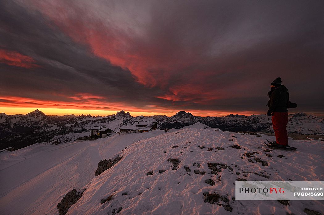 Hiker near the summit of Piccolo Lagazuoi just before dawn, in the background Antelao, Pelmo and Civetta mountains, Cortina d'AMpezzo, dolomites, Veneto, Italy, Europe
