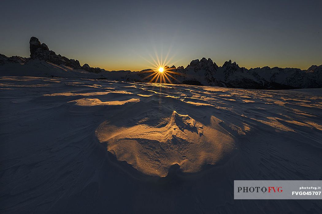 Beautiful sunrise behind Le Ciampedele, between the western side of the Tre Cime di Lavaredo and the Cadini di Misurina, on a frosty december morning, dolomites, South Tyrol, Italy, Europe