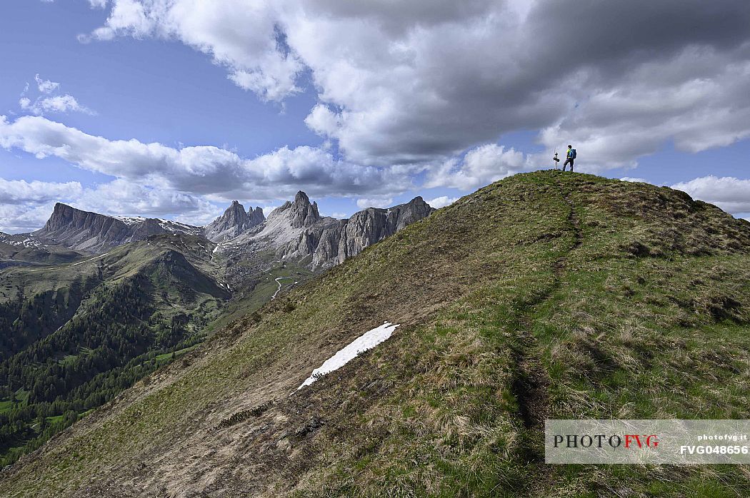 Hiker on the top of Col de la Puina mount towards the Lastoni di Formin, Croda da Lago and the Becco di Mezzod mountains, dolomites, Veneto, Italy, Europe