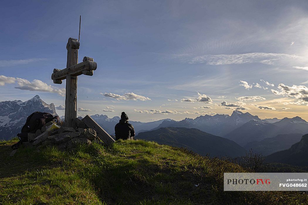 Hiker waits for the sunset from the top of Col de la Puina admiring the Marmolada, on the left the Civetta mount, dolomites, Veneto, Italy, Europe