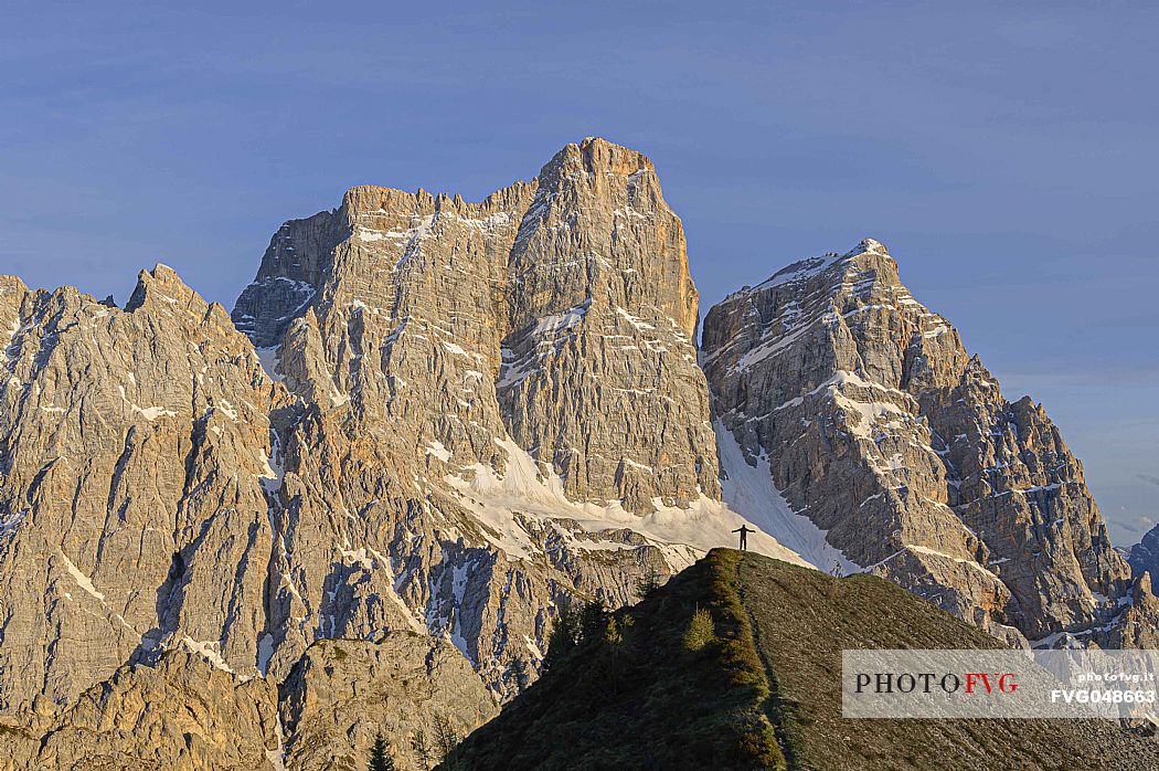 Hiker in front of the west face of the Pelmo peak, Veneto, dolomites, Italy, Europe