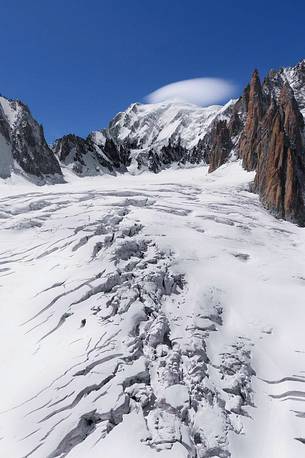 Top of Mont Blanc wrapped in lenticular cloud, crevasse on the Glacier du Géant, Courmayeur, Aosta valley, Italy, Europe Top of Mont Blanc wrapped in lenticular cloud, crevasse on the Glacier du Géant, Courmayeur, Aosta valley, Italy, Europe