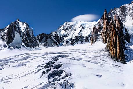 Top of Mont Blanc wrapped in lenticular cloud, crevasse on the Glacier du Gant, Courmayeur, Aosta valley, Italy, Europe