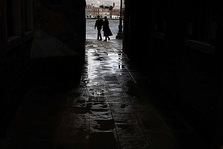 Pair in silhouette after the storm at the Zattere in front of the Giudecca, Venice, Veneto, Italy, Europe Pair in silhouette after the storm at the Zattere in front of the Giudecca, Venice, Veneto, Italy, Europe