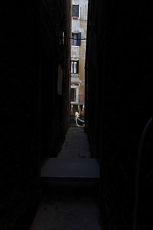 Detail of Gondola seen through a narrow alley, Venice, Italy Detail of Gondola seen through a narrow alley, Venice, Italy