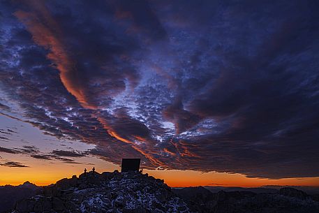 Luca Vuerich bivouac in an autumn sunrise, Foronon del Buinz, Montasio mount, Julian alps, Friuli Venezia Giulia, Italy, Europe