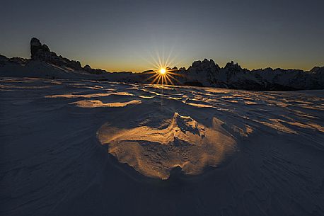 Beautiful sunrise behind Le Ciampedele, between the western side of the Tre Cime di Lavaredo and the Cadini di Misurina, on a frosty december morning, dolomites, South Tyrol, Italy, Europe Beautiful sunrise behind Le Ciampedele, between the western side of the Tre Cime di Lavaredo and the Cadini di Misurina, on a frosty december morning, dolomites, South Tyrol, Italy, Europe