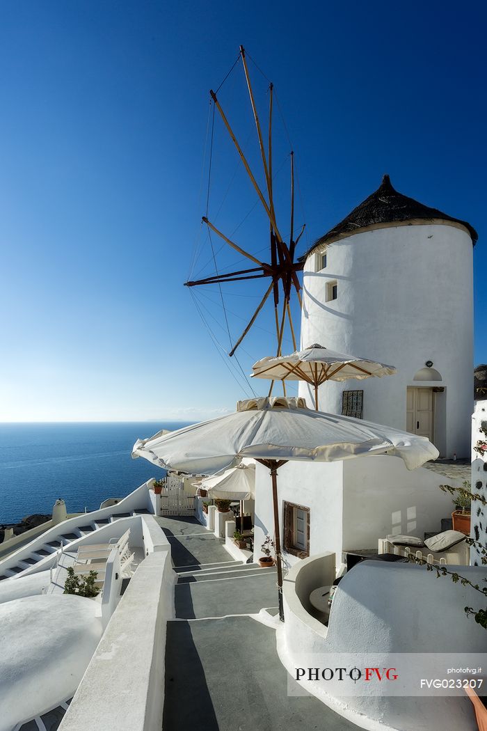 Typical windmill on top of Oia city in Santorini, Greece