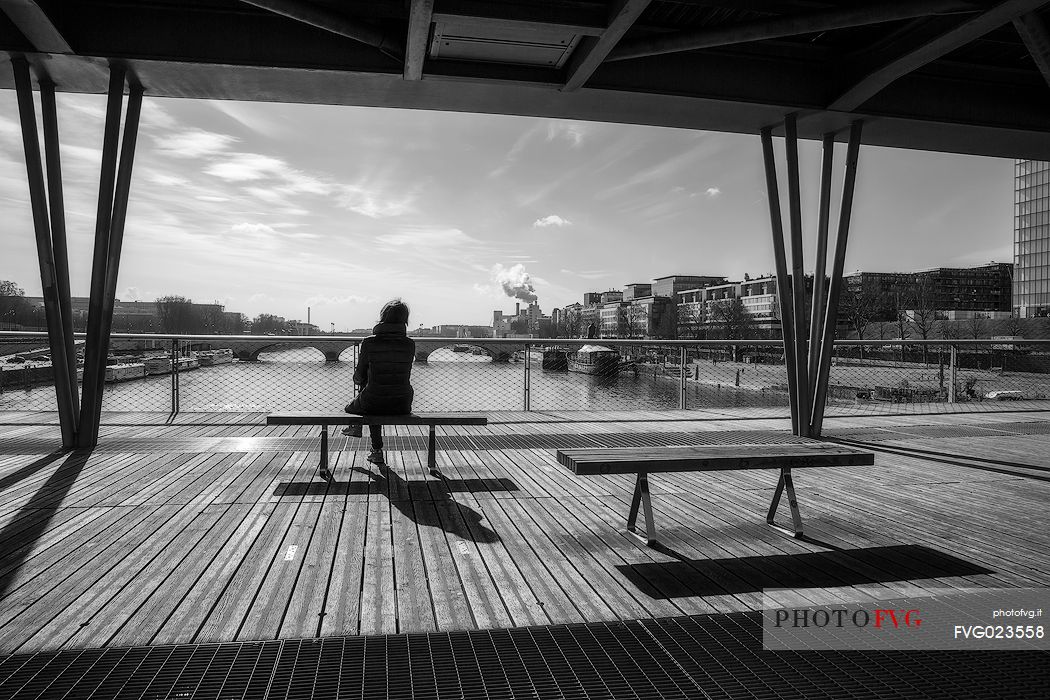 Tourist at passerelle Simone de Beauvoir. Paris, France