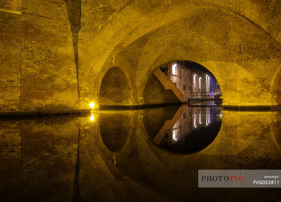 Details and reflections of Triple-bridge, Ponte dei Trepponti, called Ponte Pallotta (1638 Luca Danese architect), famous bridge landmark of town of Comacchio