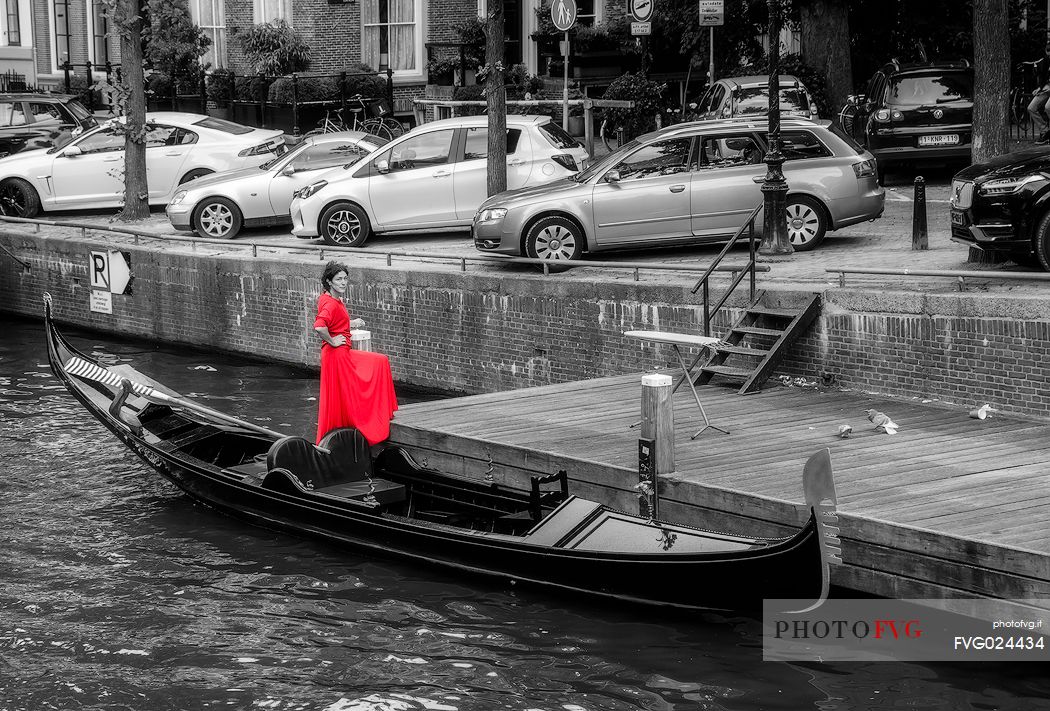 The woman in red and her gondola, Amsterdam, Holland