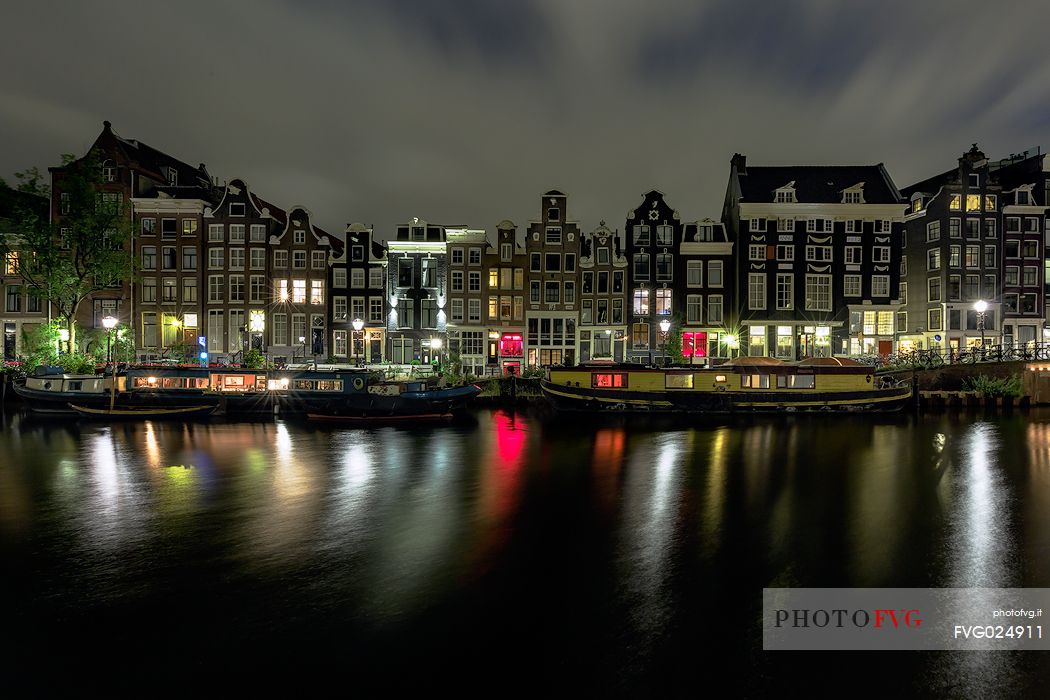 Amsterdam Canal House and boat house (floating house) in Amsterdam, Holland