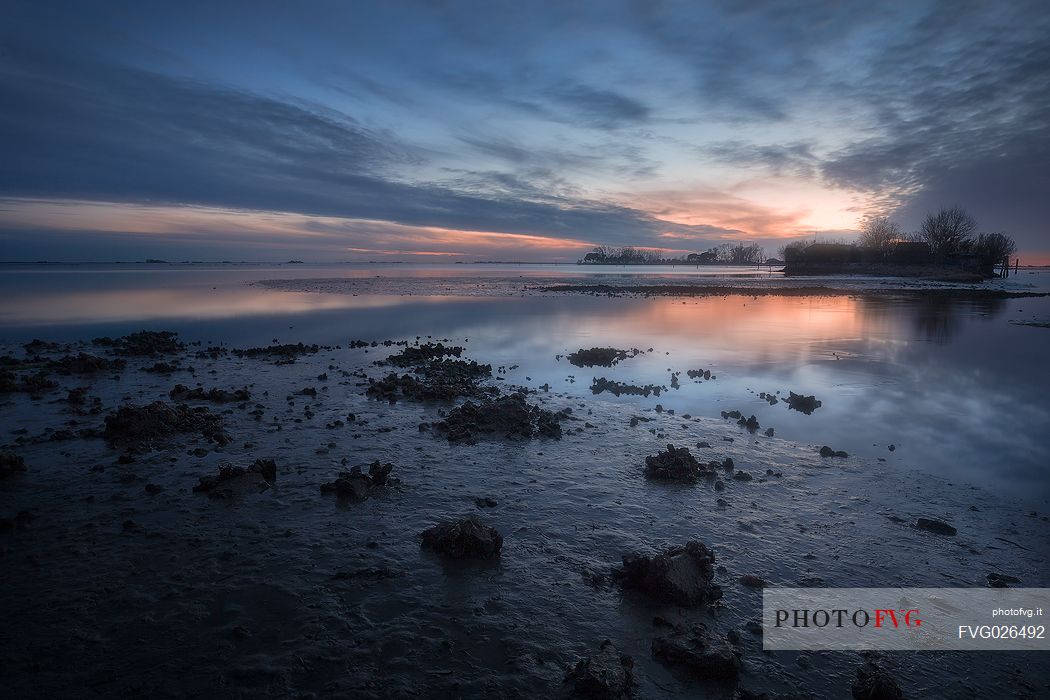 Muddy water and traditional village in Grado lagoon, Friuli Venezia Giulia, Italy