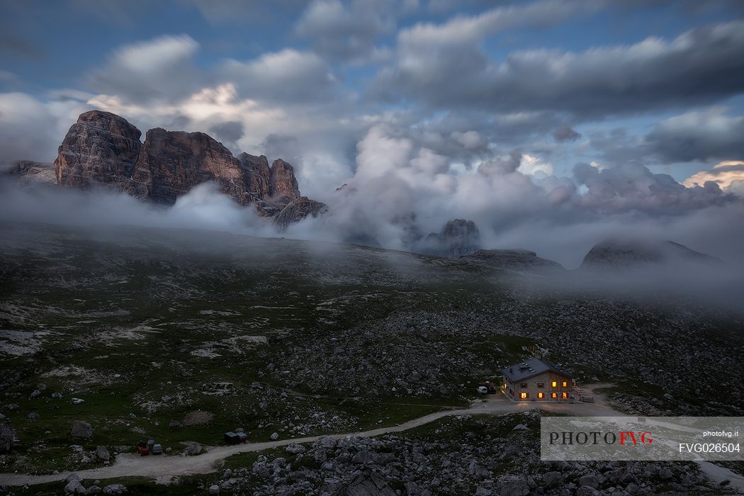 Lavaredo hut wrapped by clouds at dusk, Tre Cime natural park, dolomites, Italy