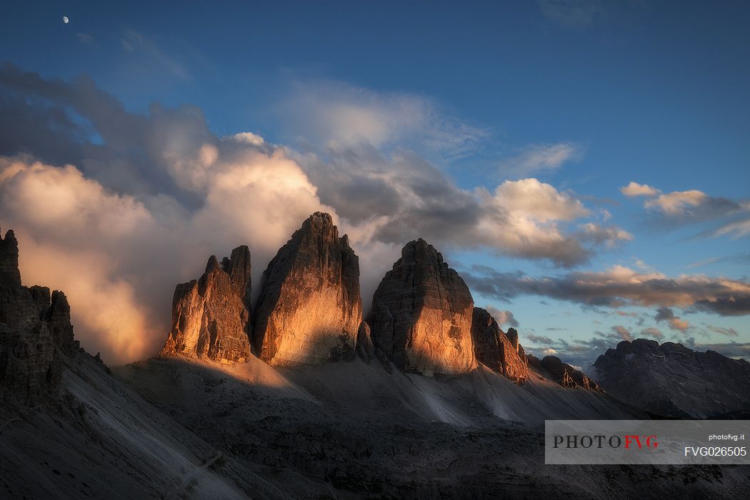 Tre cime di Lavaredo peak painted by sunlight, dolomites, South Tyrol, Italy