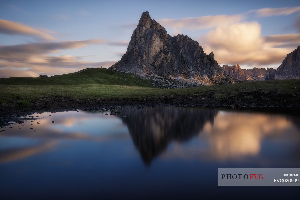 Mirror reflection of Ra Gusela mountain at sunrise, Giau pass, Cortina d'Ampezzo, Italy