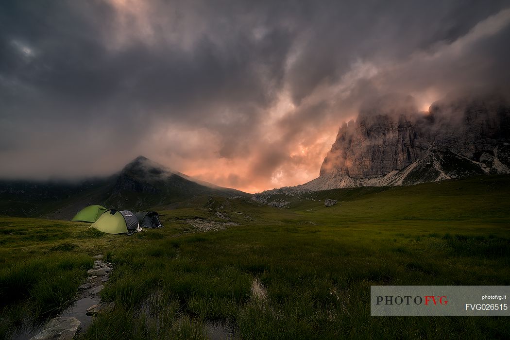 Moonlight campground in front of Croda da Lago mountain, Cadore, dolomites, Italy