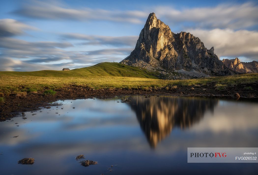 Mirror reflection of Ra Gusela mountain at sunrise, Giau pass, Cortina d'Ampezzo, Italy