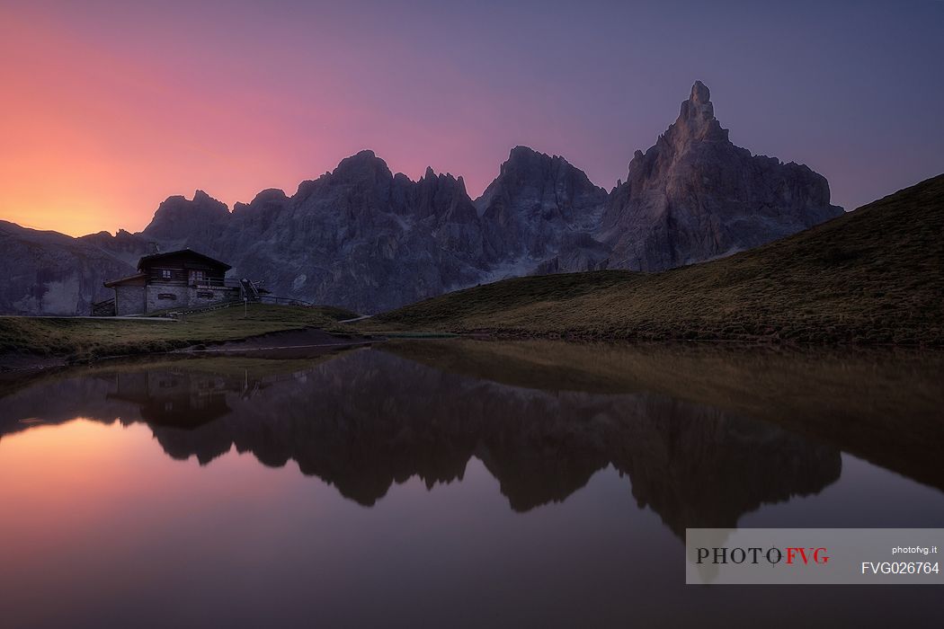 Baita Segantini hut and in the background the Pale di San Martino mountain range, dolomites, Italy