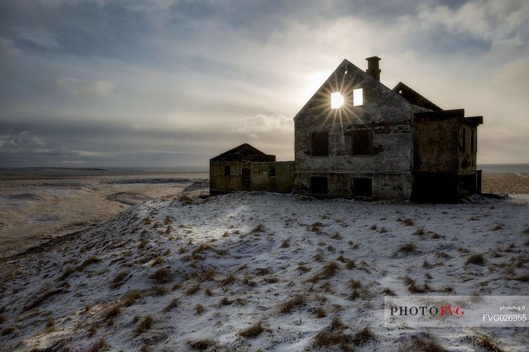 Sunrise in the house ruins at Londrangar coast, Iceland