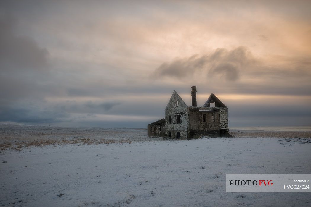 Sunrise in the house ruins at Londrangar coast, Iceland