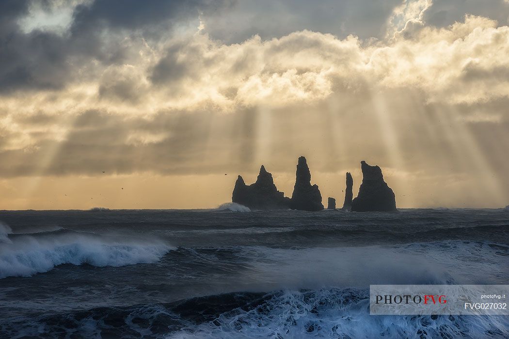 Reynisdrangar cliffs, volcanic rock formations on the coast in the storm, Vik i Myrdal, Iceland