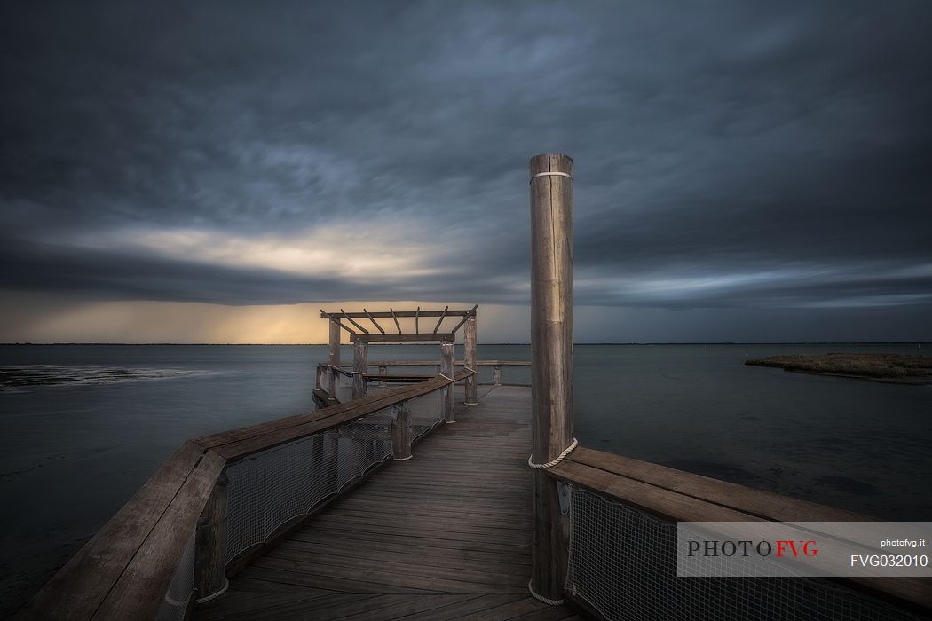 Pier on lungolaguna Trento in Lignano Sabbiadoro, Adriatic sea, Friuli Venezia Giulia, Italy
