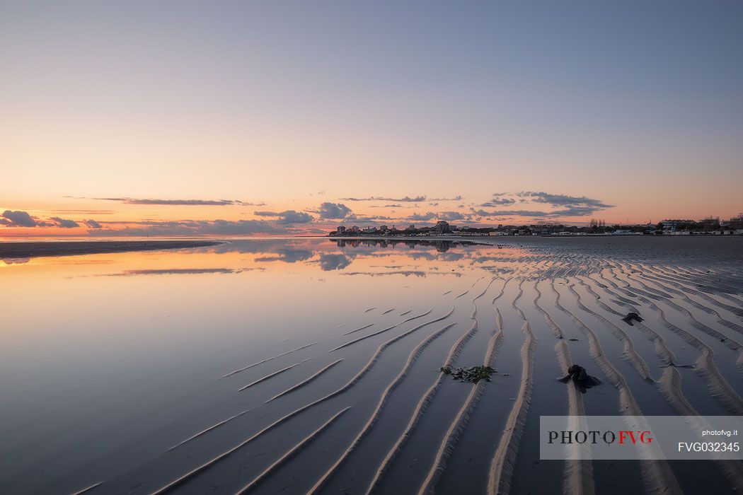 Shoreline reflections in Grado Island at sunset, Friuli Venezia Giulia, Italy