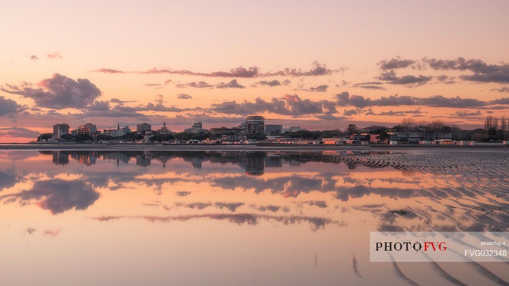 Shoreline golden reflections in Grado lagoon at sunset, Friuli Venezia Giulia, Italy