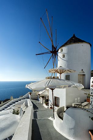 Typical windmill on top of Oia city in Santorini, Greece