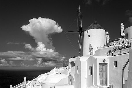Windmill on top of Oia village in Santorini island, Greece. Black & white shot