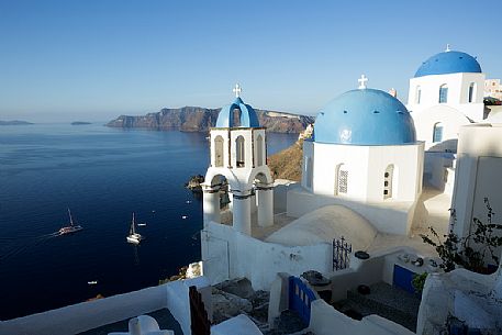 Church roof in Oia village and Caldera in the background, Santorini island, Greece