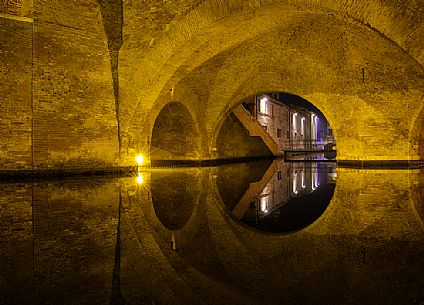 Details and reflections of Triple-bridge, Ponte dei Trepponti, called Ponte Pallotta (1638 Luca Danese architect), famous bridge landmark of town of Comacchio Details and reflections of Triple-bridge, Ponte dei Trepponti, called Ponte Pallotta (1638 Luca Danese architect), famous bridge landmark of town of Comacchio