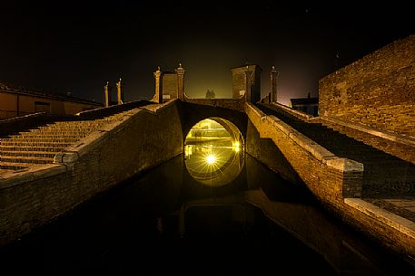 Triple bridge, Ponte dei Trepponti, called Ponte Pallotta (1638 Luca Danese architect), famous bridge landmark of town of Comacchio Triple bridge, Ponte dei Trepponti, called Ponte Pallotta (1638 Luca Danese architect), famous bridge landmark of town of Comacchio