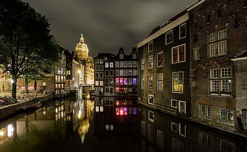 De Wallen, the largest and historic red lights district in Amsterdam, the canal Oudezijds Voorburgwal and the Basilica of Saint Nicholas and its mirror reflection, Holland, Netherlands. De Wallen, the largest and historic red lights district in Amsterdam, the canal Oudezijds Voorburgwal and the Basilica of Saint Nicholas and its mirror reflection, Holland, Netherlands.