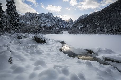 Fusine lake and Marngart mountain range in winter, Julian alps, Italy