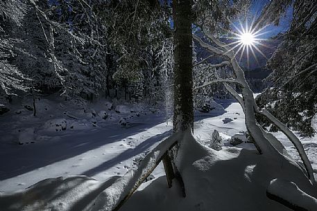 Fusine lake and Marngart mountain range in winter, Julian alps, Italy