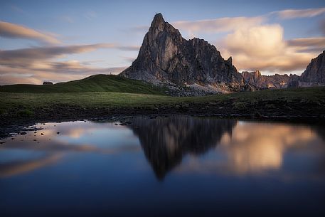 Mirror reflection of Ra Gusela mountain at sunrise, Giau pass, Cortina d'Ampezzo, Italy