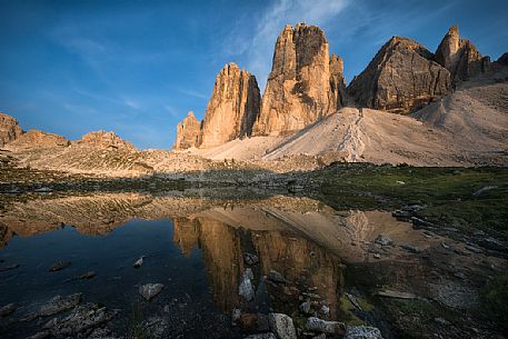 Tre Cime di Lavaredo, Drei Zinnen, reflected in a small lake at sunset, dolomites, Italy